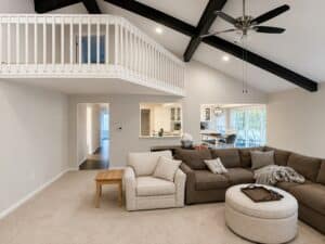 Modern living room with interior paint and drywall finishing, vaulted ceiling with black beams, Clarkston MI